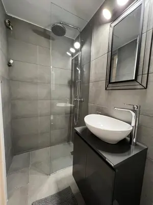 a bathroom with a sink and a glass shower at Your studio Athens in Athens