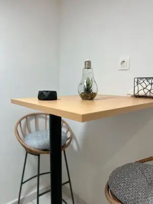 a wooden table with two stools underneath a table at Your studio Athens in Athens