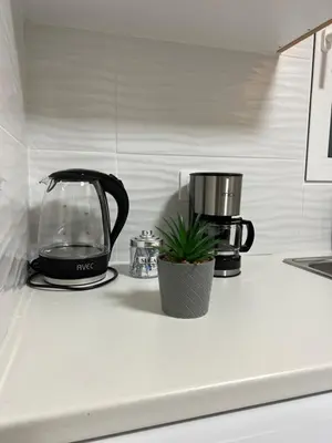 a kitchen counter with a coffee maker and a blender at Your studio Athens in Athens
