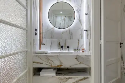 a bathroom with a marble sink and a mirror at 3bdr Modern Design & Bright Interiors in Plaka in Athens