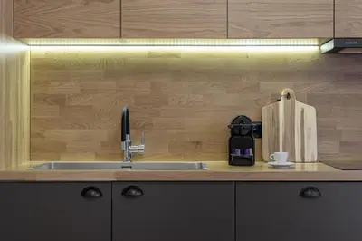 a kitchen with a sink and a wooden wall at 3bdr Modern Design & Bright Interiors in Plaka in Athens