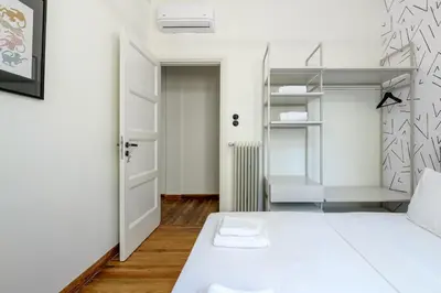 a bedroom with a white bed and a closet at 3bdr Modern Design & Bright Interiors in Plaka in Athens