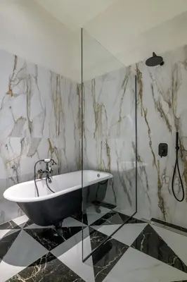a bathroom with a tub and a glass shower at 3bdr Modern Design & Bright Interiors in Plaka in Athens