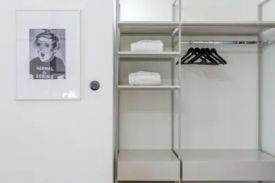 a bathroom with a shelf with towels and a door at 3bdr Modern Design & Bright Interiors in Plaka in Athens