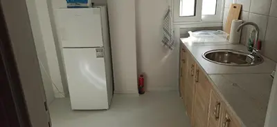 a kitchen with a white refrigerator and a sink at 2 Bed Flat - Sleeps 5 - Parking - Wifi in Athens
