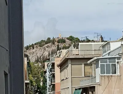a hill in the middle of a city with buildings at 2 Bed Flat - Sleeps 5 - Parking - Wifi in Athens