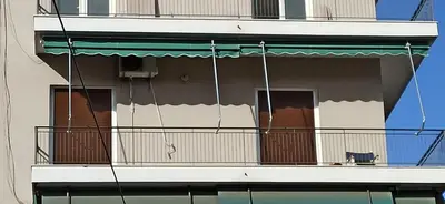 a cat sitting on a balcony of a building at 2 Bed Flat - Sleeps 5 - Parking - Wifi in Athens