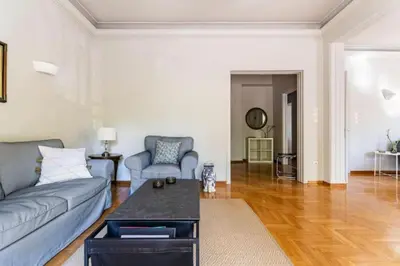 a living room with a couch and a table at Spacious renovated flat in the Athens Riviera in Athens
