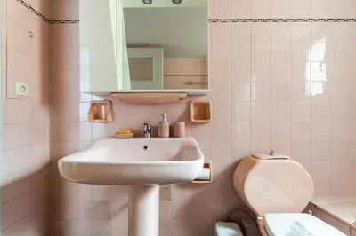 a bathroom with a sink and a toilet at Spacious renovated flat in the Athens Riviera in Athens