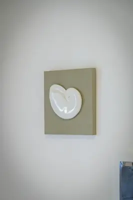 a glass heart in a box on a wall at Lush Emerald apt steps from Acropolis & Plaka! in Athens