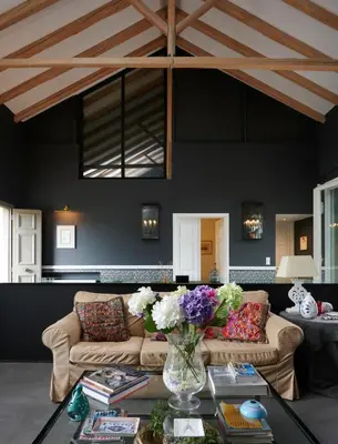 a living room with a couch and a table with flowers at Varaba Country House in Markopoulo