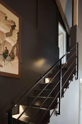 a staircase in a house with a painting on the wall at Varaba Country House in Markopoulo