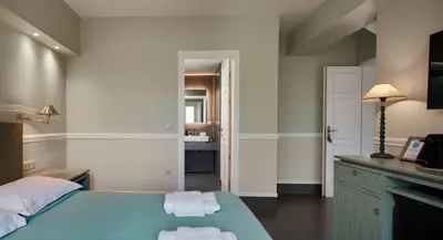 a bedroom with a bed with towels on it at Varaba Country House in Markopoulo