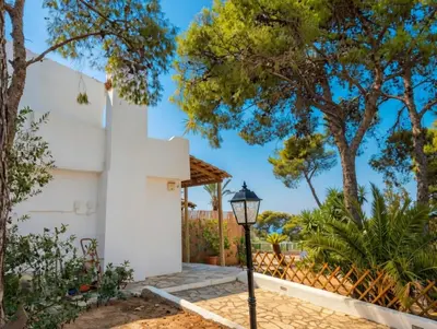 a street light in front of a white house at Villa Hermes in Vouliagmeni