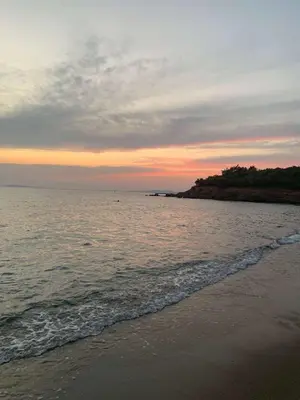 a sunset on the beach with the ocean at Saronida beach apartments kids and pets friendly in Saronida