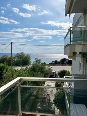 a balcony of a building with a view of the ocean at Saronida beach apartments kids and pets friendly in Saronida