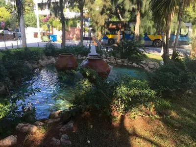 a fire hydrant in the middle of a pond at A7 Beauty Vouliagmeni Apt in a unique Spot in Athens