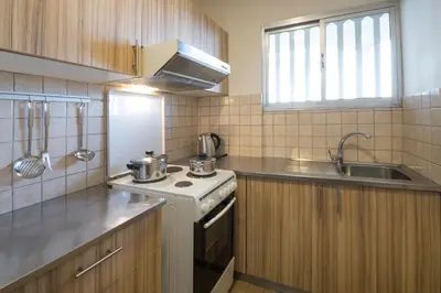 a kitchen with a stove and a sink at Marina Alimos Hotel Apartments in Athens