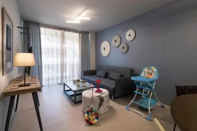 a living room with a couch and a chair at Marina Alimos Hotel Apartments in Athens