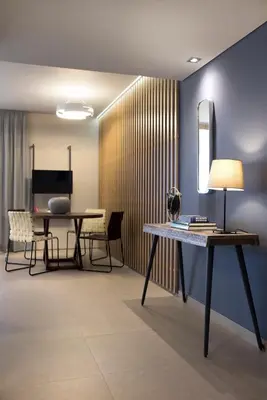 a living room with a table with a lamp and chairs at Marina Alimos Hotel Apartments in Athens