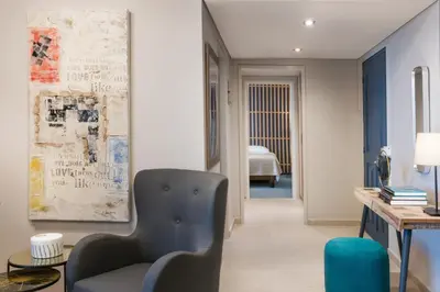 a living room with a chair and a table at Marina Alimos Hotel Apartments in Athens