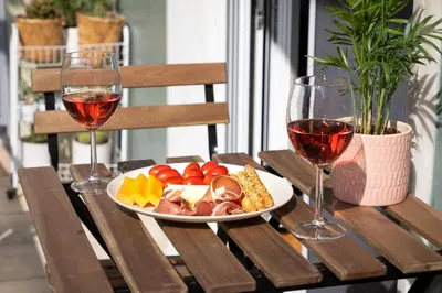 a table with a plate of food and two glasses of wine at Luxury Museum Apartment Athena in Athens