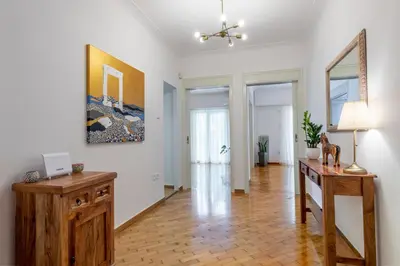 a living room with a desk and a painting on the wall at Luxury Museum Apartment Athena in Athens