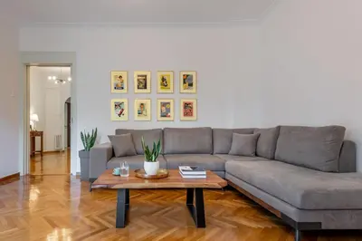 a living room with a couch and a coffee table at Luxury Museum Apartment Athena in Athens