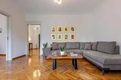 a living room with a couch and a coffee table at Luxury Museum Apartment Athena in Athens
