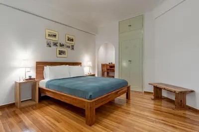 a bedroom with a bed and a wooden floor at Luxury Museum Apartment Athena in Athens
