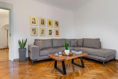 a living room with a couch and a coffee table at Luxury Museum Apartment Athena in Athens