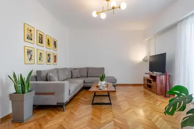a living room with a couch and a table at Luxury Museum Apartment Athena in Athens