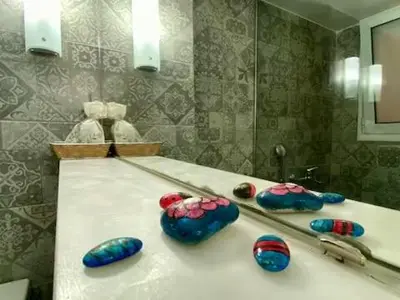 a bathroom with a mirror and some balls on a counter at Bright & Cozy 1BR in Athens city center in Athens