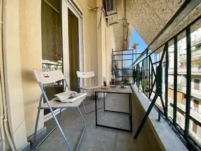 a balcony with a table and chairs on a building at Bright & Cozy 1BR in Athens city center in Athens