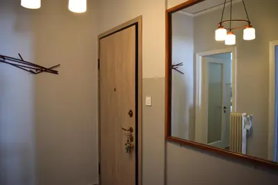 a bathroom with a mirror and a wooden door at Bright & Cozy 1BR in Athens city center in Athens