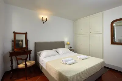 a bedroom with a bed with towels on it at Muazzo Plaka Homes, Upper Home with Balcony & Ground Home No Balcony, by ThinkVilla in Athens