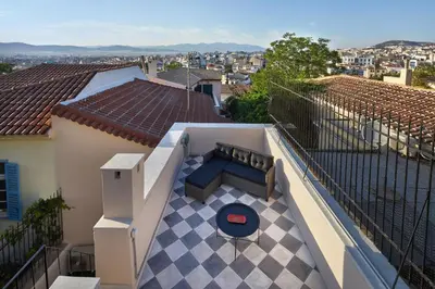 a balcony of a house with a bench on it at Muazzo Plaka Homes, Upper Home with Balcony & Ground Home No Balcony, by ThinkVilla in Athens