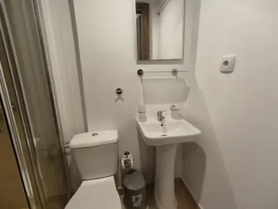 a white bathroom with a toilet and a sink at PURE URBAN PREMIUM METRO AGIOS NIKOLAOS in Athens