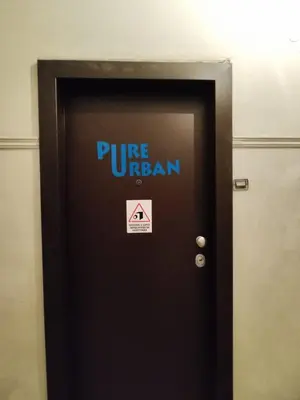 a black door with a pure neuron sign on it at PURE URBAN PREMIUM METRO AGIOS NIKOLAOS in Athens