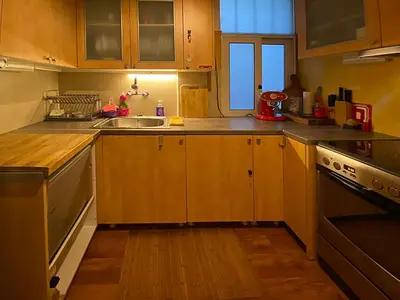 a kitchen with wooden cabinets and a sink at Nest in Mets in Athens