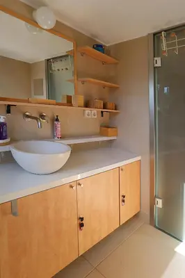 a bathroom with a sink and a glass shower at Nest in Mets in Athens