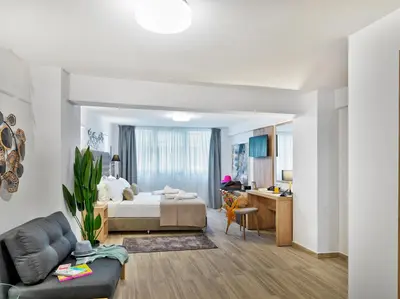a bedroom with a bed and a living room at Acropolis City Life BH in Athens