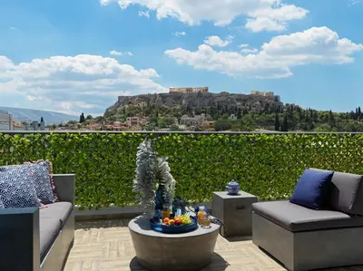 a patio with a fountain and a view of a mountain at Acropolis City Life BH in Athens