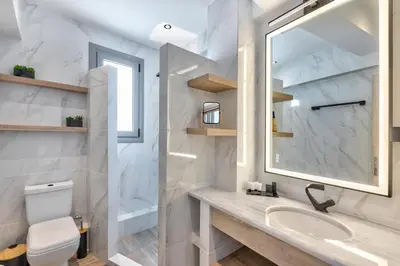a white bathroom with a sink and a mirror at Acropolis City Life BH in Athens