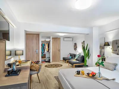 a room with a bed and a living room at Acropolis City Life BH in Athens