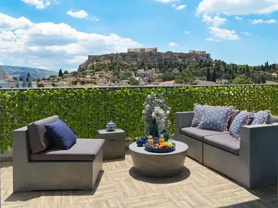 a patio with two chairs and a table with a view at Acropolis City Life BH in Athens
