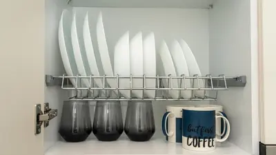 a row of cups and mugs on a shelf at Modern studio Chiou in Athens