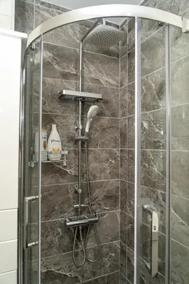 a shower with a glass door in a bathroom at Modern studio Chiou in Athens