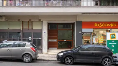 two cars parked in front of a storefront at Modern studio Chiou in Athens