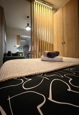 a bedroom with a bed with a towel on it at PSH -Stylish Quiet Top Floor Apt- Near Acropolis in Athens
